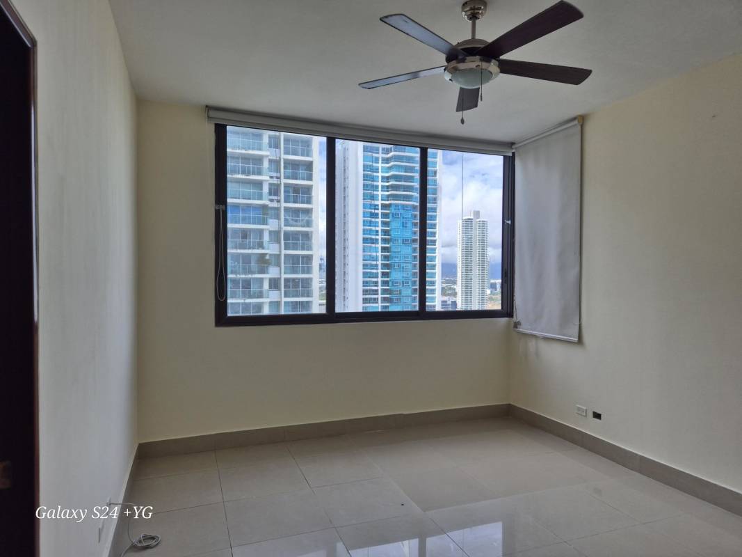 Bedroom with large window, ceiling fan, city view PH Panama Bay Costa del Este