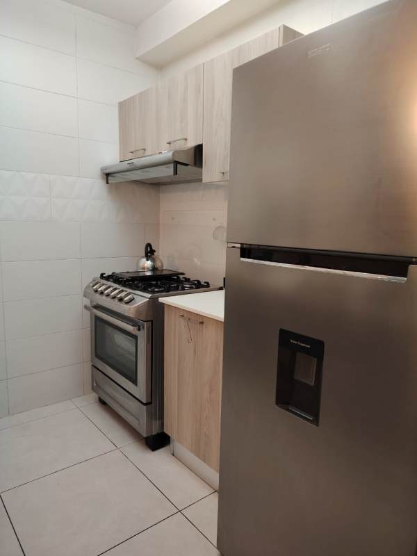 Spacious living room with balcony and city skyline view in PH Vivendi Green Edison Park