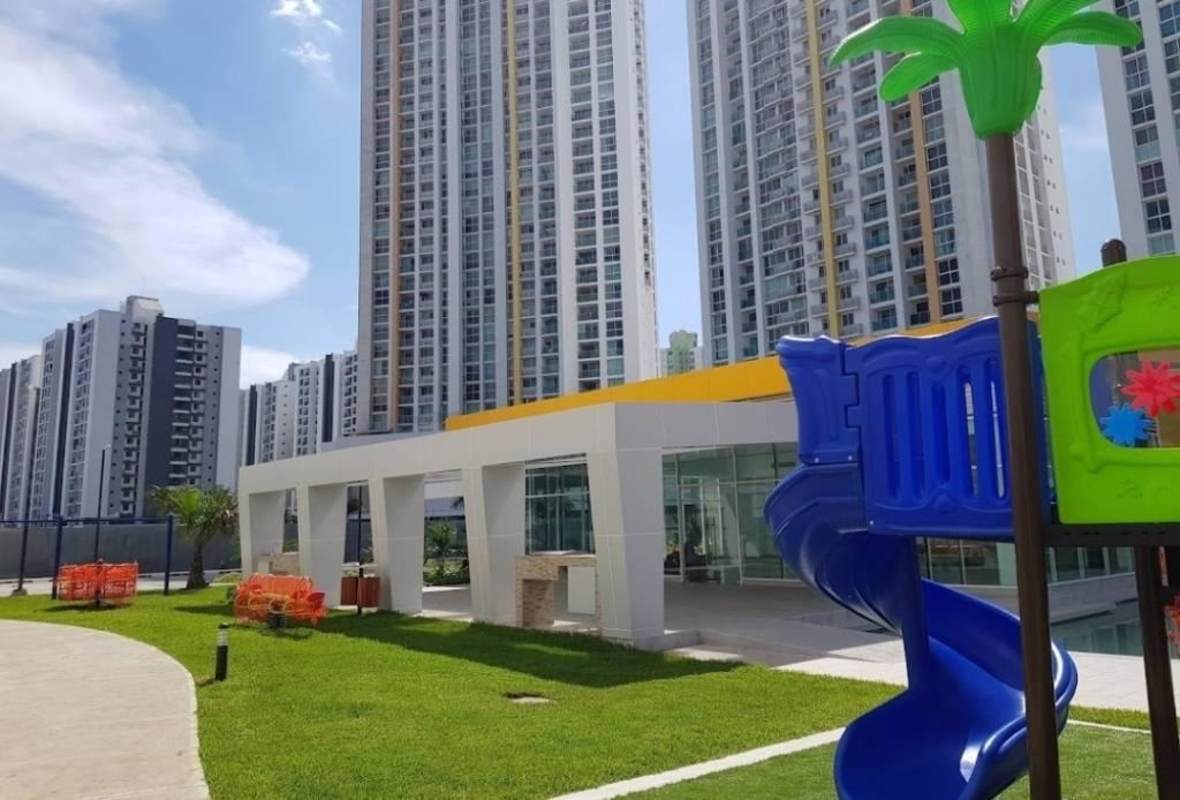 Apartment towers with colorful children's playground and green space at PH Kings Park Condado del Rey Panama City