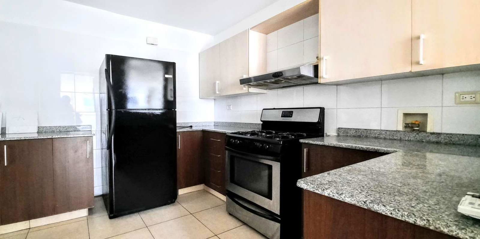 Modern kitchen with granite countertops and stylish backsplash in PH Serenade Costa del Este Panama City