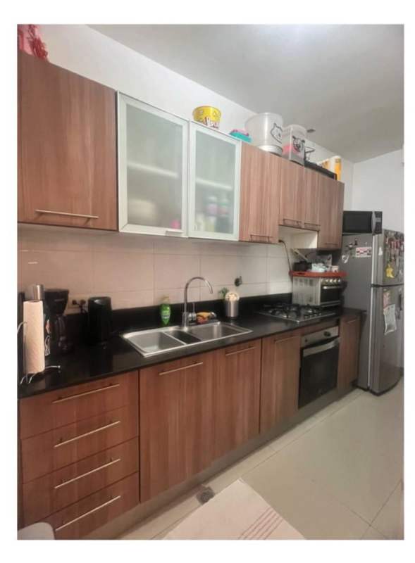 Modern kitchen with wood cabinets and black countertops PH Diamond Tower Panama