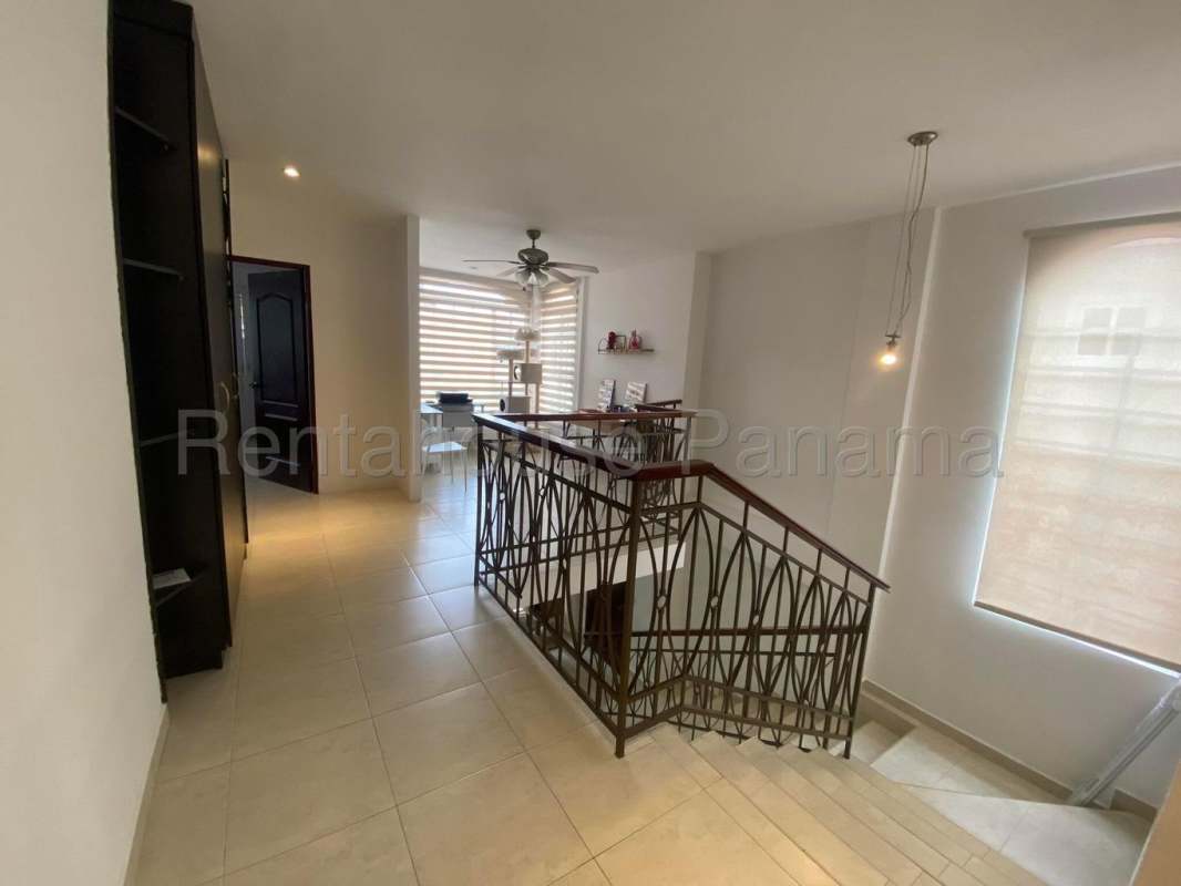 Large backyard lawn with palm trees in Villa Valencia Costa Sur Panama City