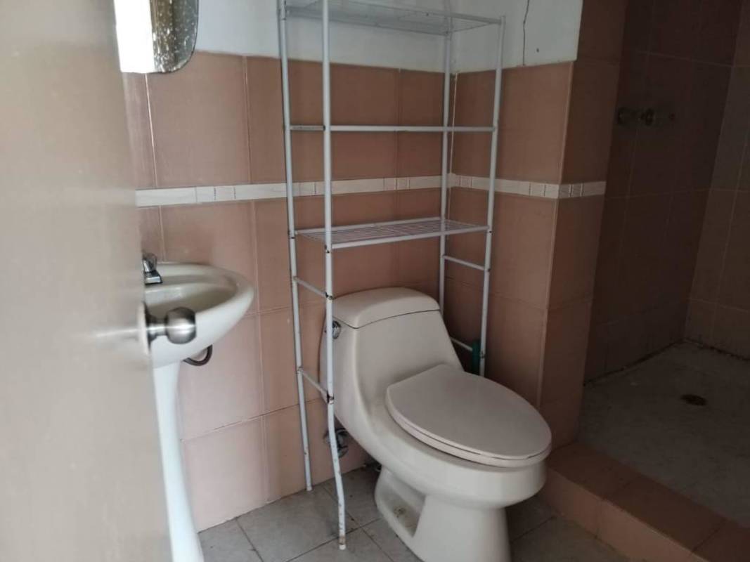Bathroom with pedestal sink, walk-in shower, beige tiles Clayton apartment Panama