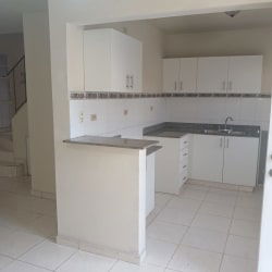 Open living and dining room with ceramic tiles and staircase in duplex house Vista Alegre Arraiján