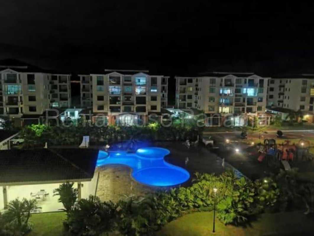 Modern balcony with glass railing overlooking city lights at PH Costamare Costa Sur Panama