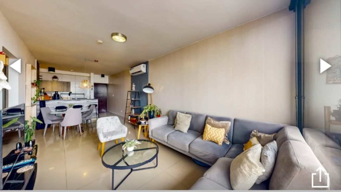 Open-plan living, dining and kitchen space in Canvas Tower apartment with panoramic windows in Panama City