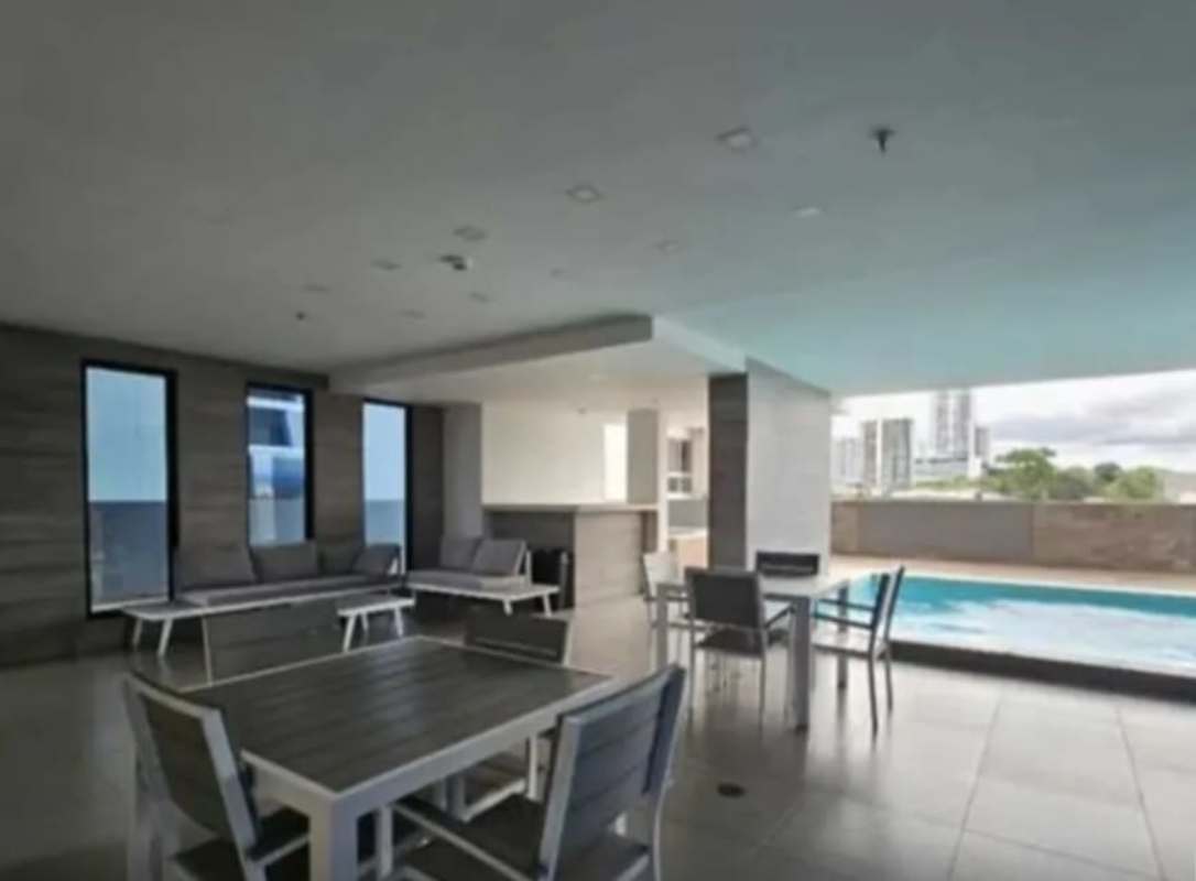 Swimming pool with city views and covered social lounge at PH Canvas Tower in Parque Lefevre Panama