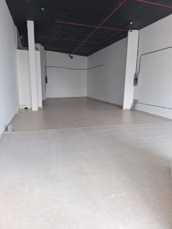 Empty commercial unit with tiled floors, white walls, black industrial ceiling PH Bay View Panama