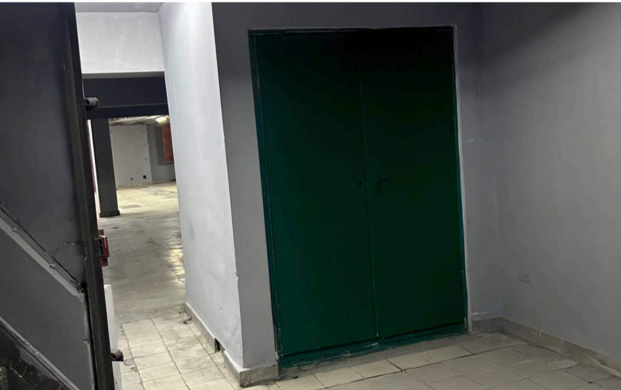 Corridor and green metal entrance doors inside warehouse Calidonia Panama