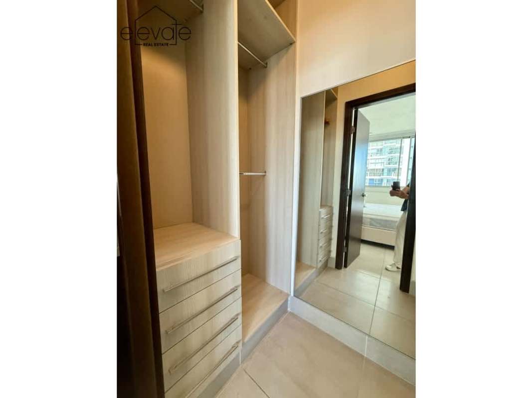 Dining space with balcony access in Jade Tower apartment with city skyline views