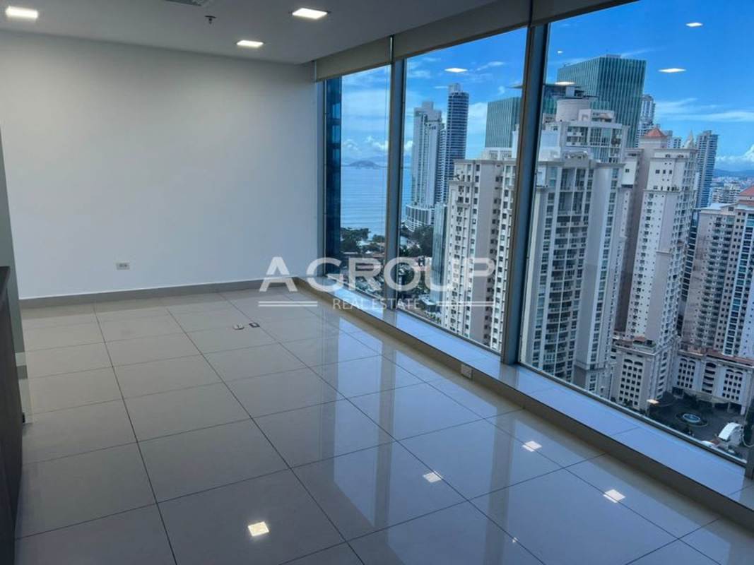 Empty open workspace with curved wall, tiled floors and recessed ceiling lights in Oceania Business Plaza Punta Pacifica