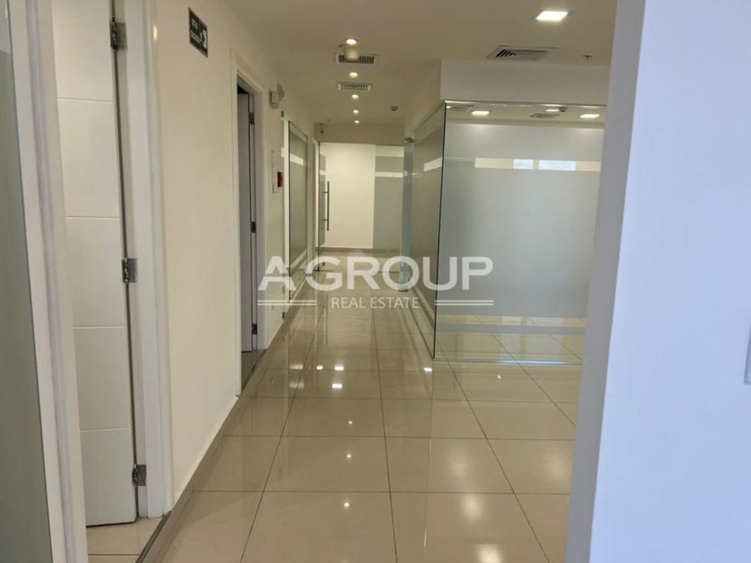 Modern hallway with glass office partitions and tiled floor in Oceania Business Center Panama
