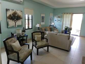 Cozy living area with split AC, large windows, light decor in beach villa Hacienda Pacifica Panama