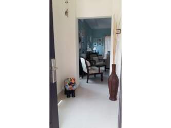 Open kitchen, dining and living room with granite counters at Hacienda Pacifica villa in San Carlos