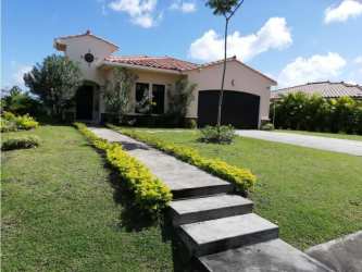 Mediterranean style villa with tile roof and landscaped yard in Hacienda Pacifica San Carlos Panama for rent