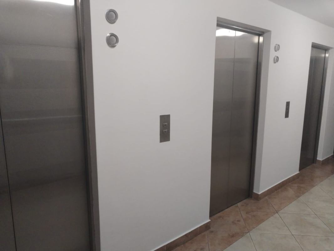 Renovated elevator lobby with stainless steel doors, marble floors PH Marquis Tower Panama