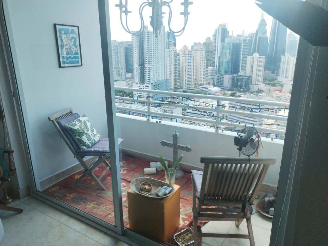 Balcony with skyline view, wood chairs, decor PH Marquis Tower Panama City