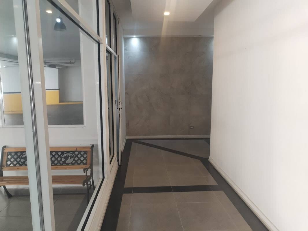 Modern hallway corridor with glass walls and parking view PH Marquis Tower Panama City