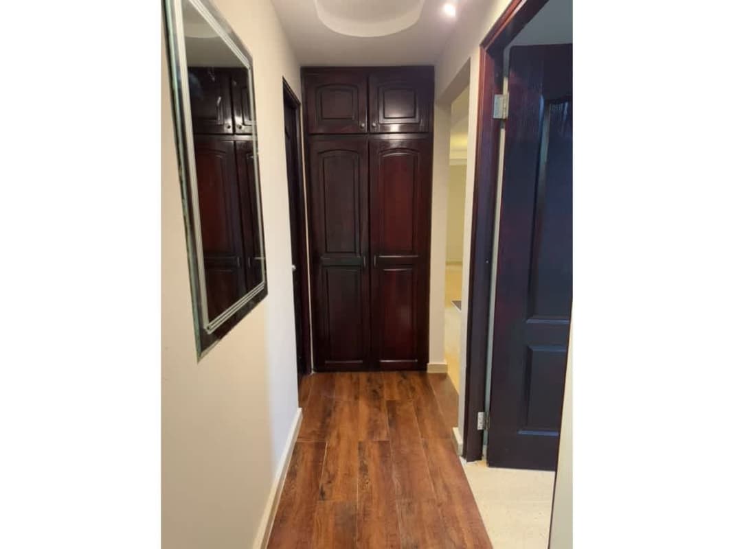 Laundry room with twin sinks, wall shelves, and tile floor in Residencial Las Americas Panama