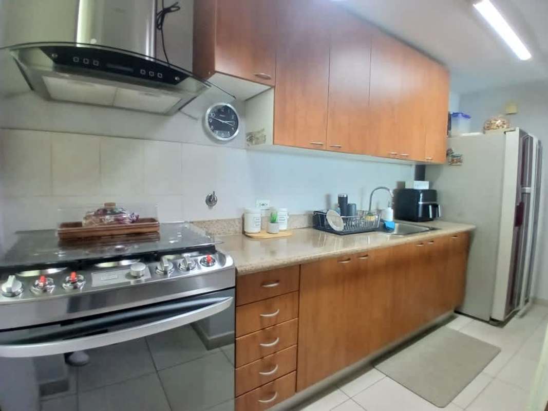 Kitchen with granite countertops, wooden cabinets and appliances in PH Bahía Pacífica San Francisco Panama
