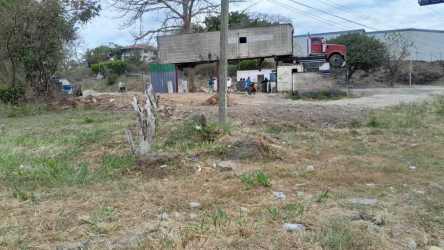 Grassy vacant land adjacent to busy highway with billboard frames Nueva Gorgona Panama
