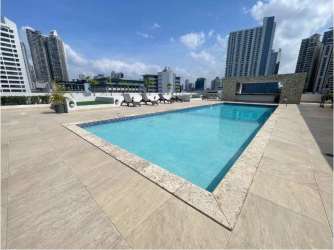 Infinity rooftop pool with deck overlooking Panama Pacifico community and skyline