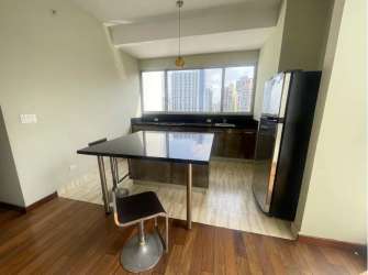 Open kitchen with quartz countertops, stainless appliances, island in PH Panama Pacifico Towers Arraiján Panama