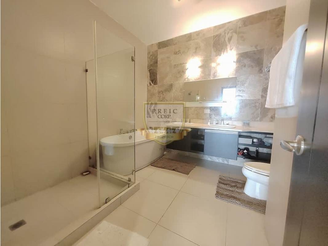 Modern bathroom with glass shower, double sink vanity at PH BICSA Tower