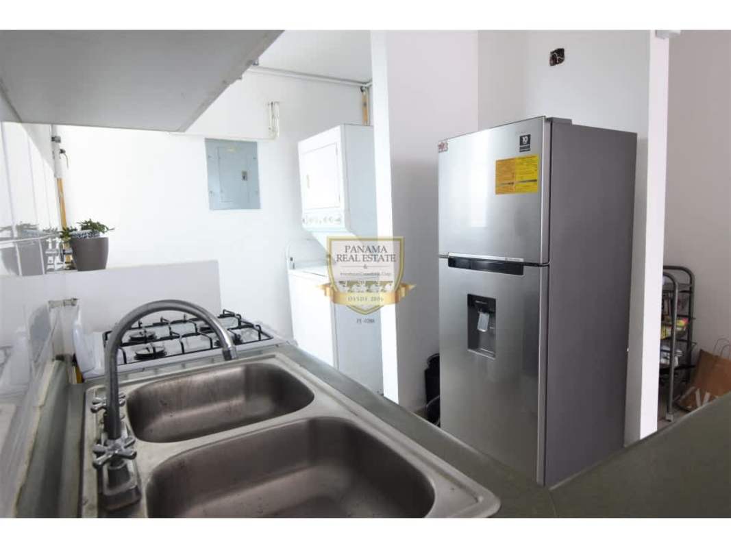 White and silver kitchen with stainless fridge and washer in PH Los Toneles Bella Vista Panama