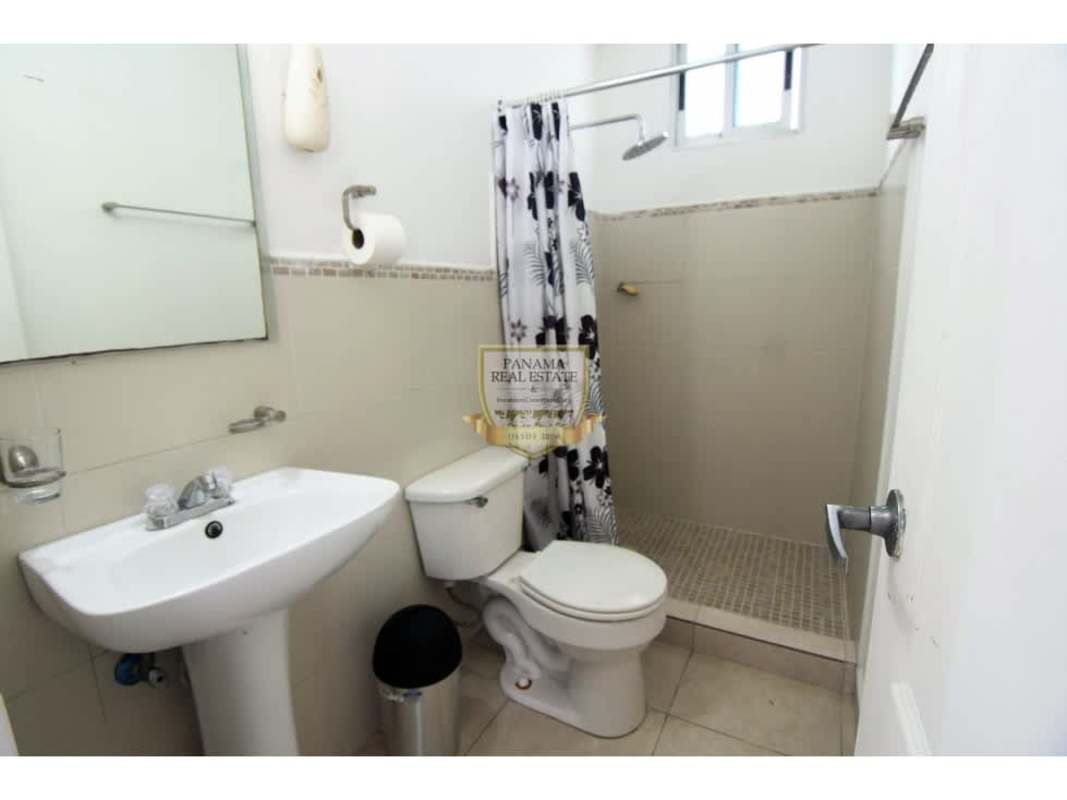 Small bathroom with pedestal sink, tile, and walk-in shower in PH Los Toneles Panama