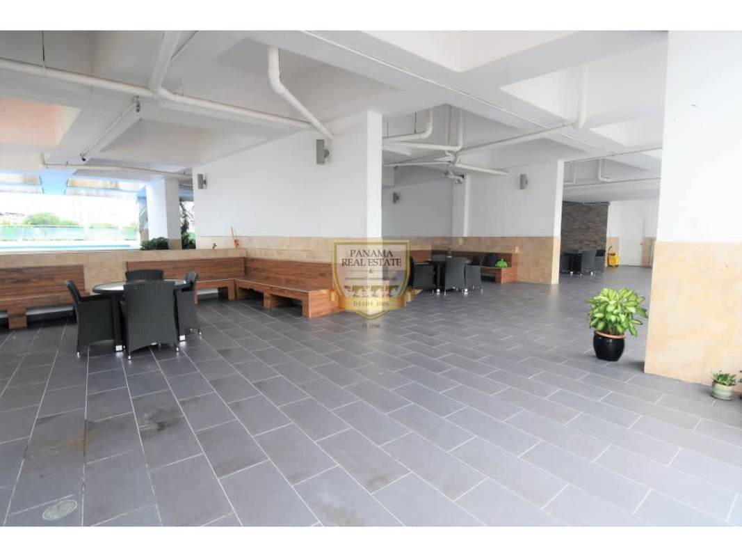 Covered patio with wood benches, tables and greenery PH Los Toneles Bella Vista Panama