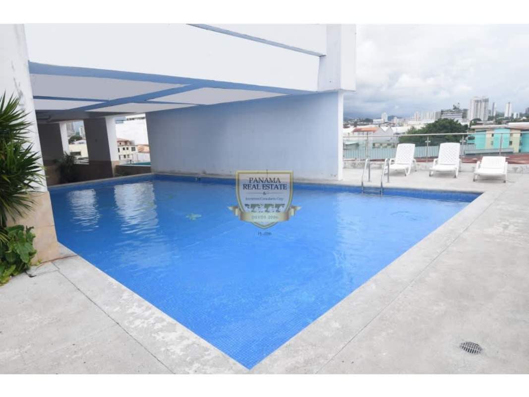 Rooftop swimming pool with lounge chairs and city views PH Los Toneles Panama
