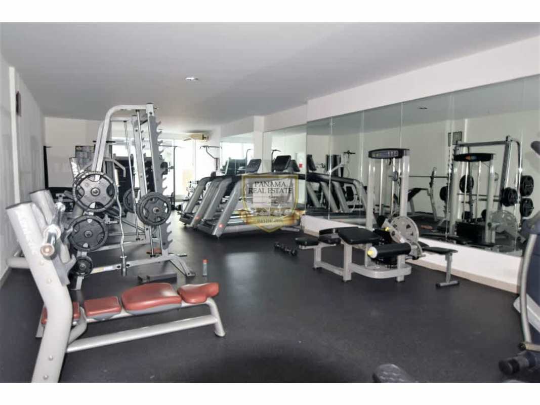Gym with cardio equipment, weight machines and mirrors in PH Los Toneles Panama