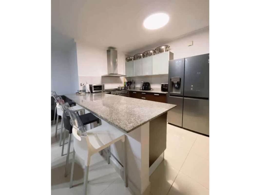 Contemporary kitchen with granite island, stainless steel appliances, and designer finishes PH Waterfalls Panama City