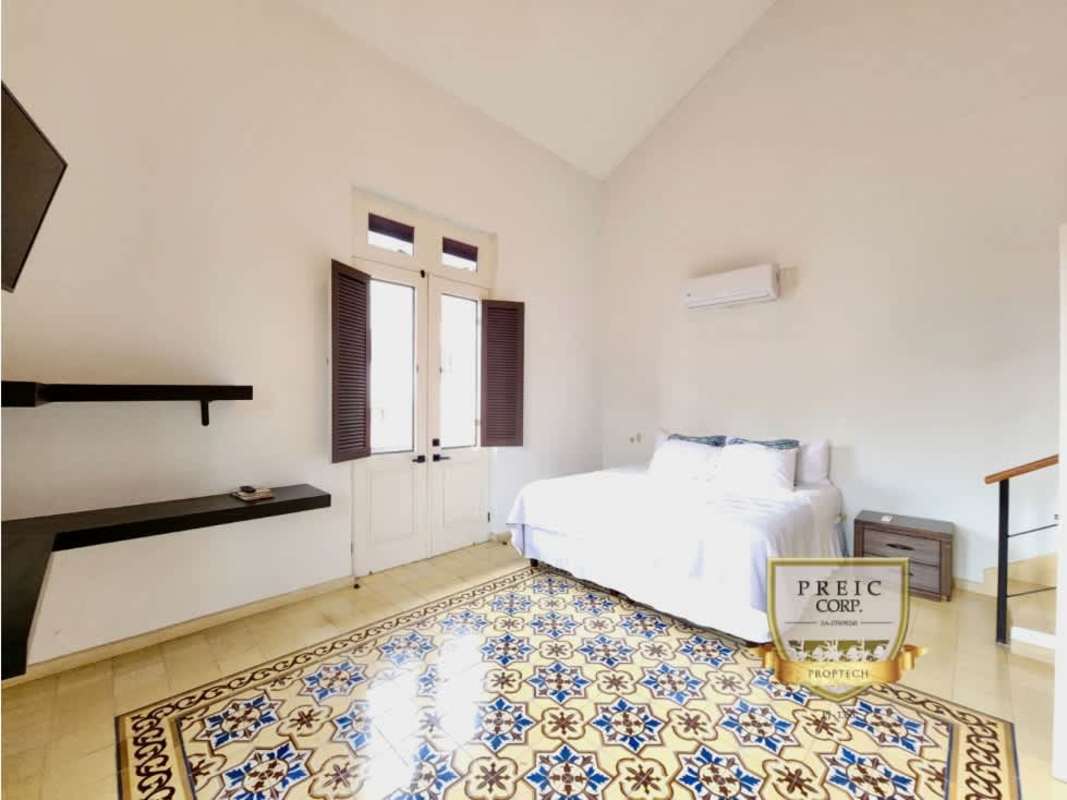 Views over terracotta rooftops, Panama Bay and bridge from Casco Viejo apartment balcony