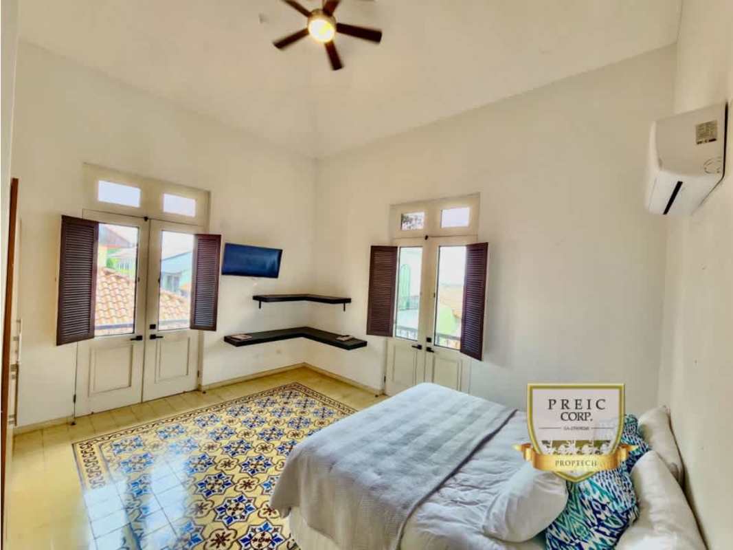 Bedroom with decorative tiles, wooden shutters, air conditioning, balcony in Casco Viejo Panama PH Casco Antiguo Lofts