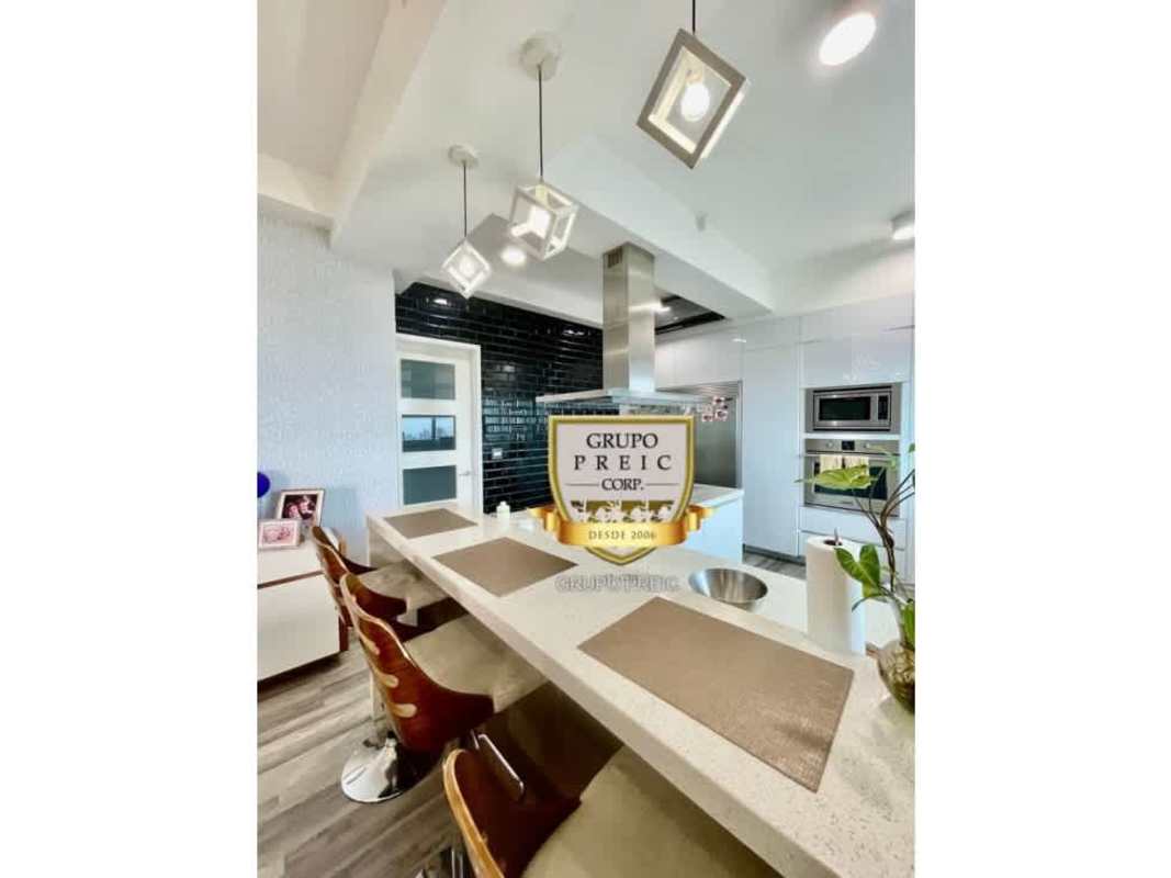 Furnished open dining-living with modern decor and skyline views at Elite 500