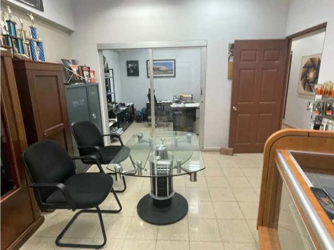 Glass table meeting space with trophy shelves in Plaza 12 de Octubre commercial unit Panama