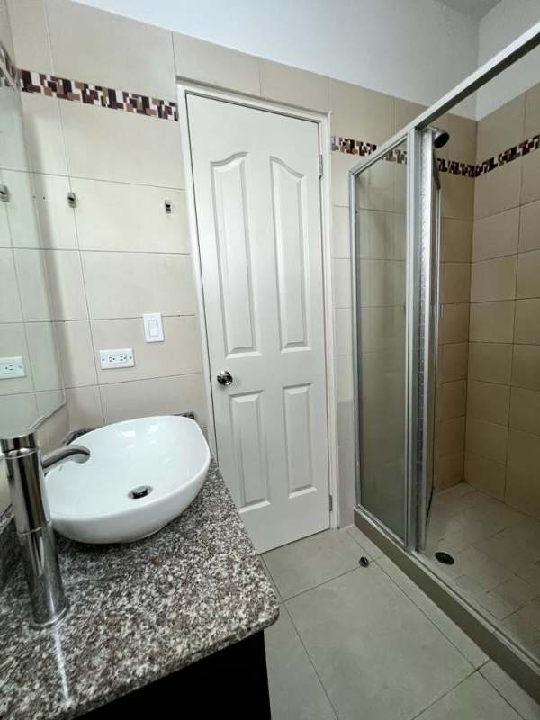 Bathroom with vessel sink, granite countertop, tiled glass shower PH Club de Golf Panama