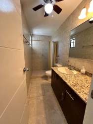 Open plan living room with large ocean-view windows at PH Biltmore Gorgona Panama