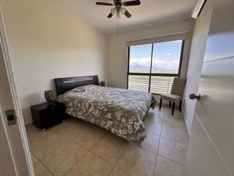 Large bedroom with panoramic ocean view windows at PH Biltmore Playa Malibu Panama