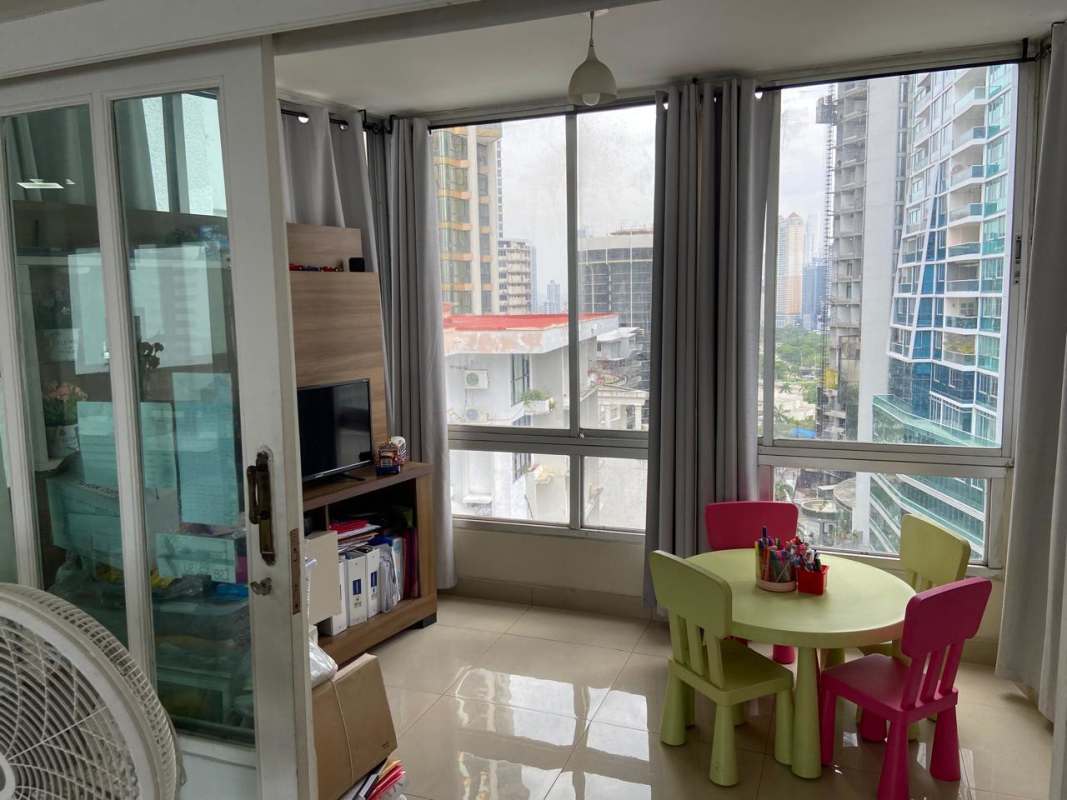 Living room with children's play corner, windows with city views in Punta Paitilla PH Las Perlas
