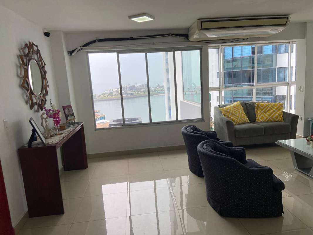 Open plan living-dining space with ocean and city views in PH Las Perlas Panama City
