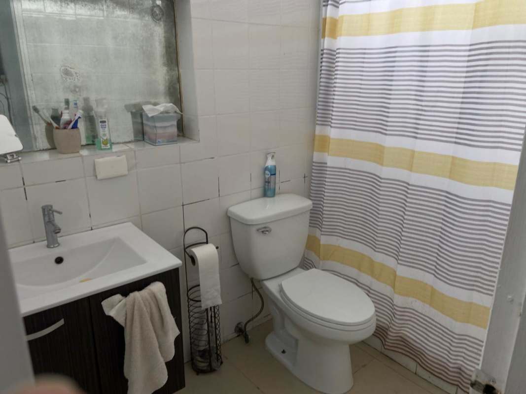 Bathroom with vanity, shower, neutral tiles in PH Las Perlas Punta Paitilla Panama