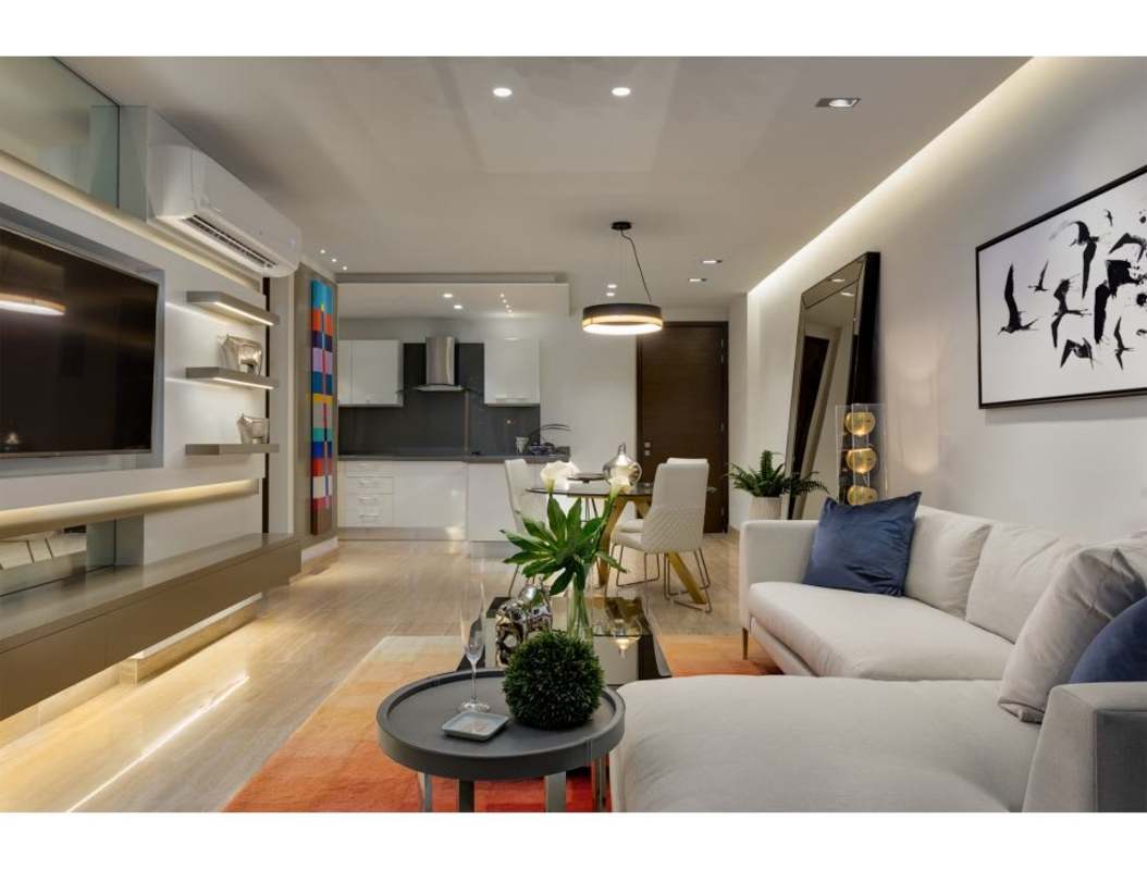 Furnished living room with sectional sofa and large windows The Regent Costa del Este Panama