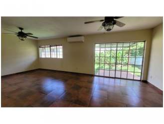 Spacious living area with ceiling fans, air conditioning unit and tiled floor in Panama Pacifico