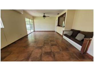 Living room with large tile floor, sliding doors, ceiling fans and built-in bench in Panama Pacifico neighborhood