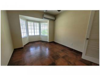 Spacious bedroom featuring bay window, split AC and tile floors in Panama Pacifico home