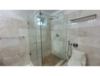 Modern bathroom with double sinks and glass shower at Tucán Country Club Villa Panama