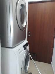Laundry room with stacked washer dryer PH Playa Blanca Panama beachfront rental